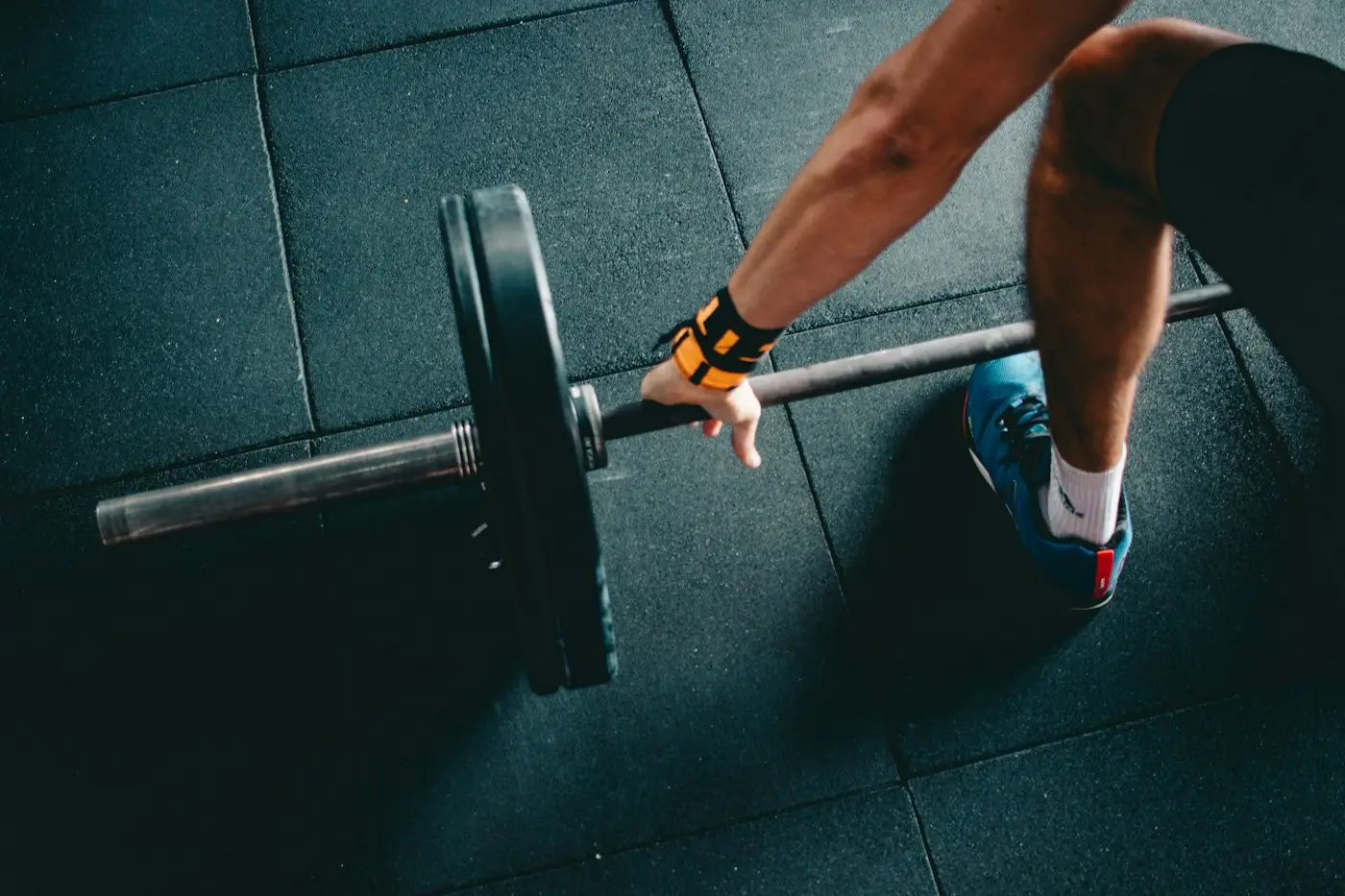 Lifter gripping a loaded barbell