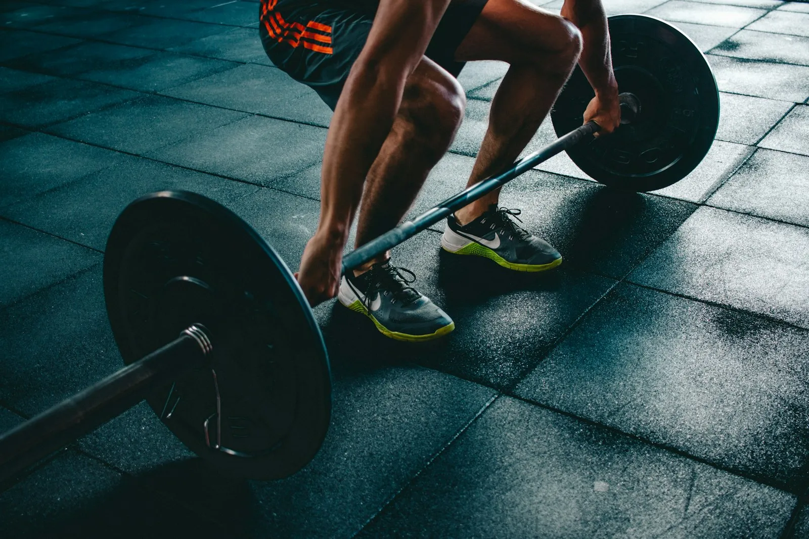 Barbell deadlift setup in a dark gym