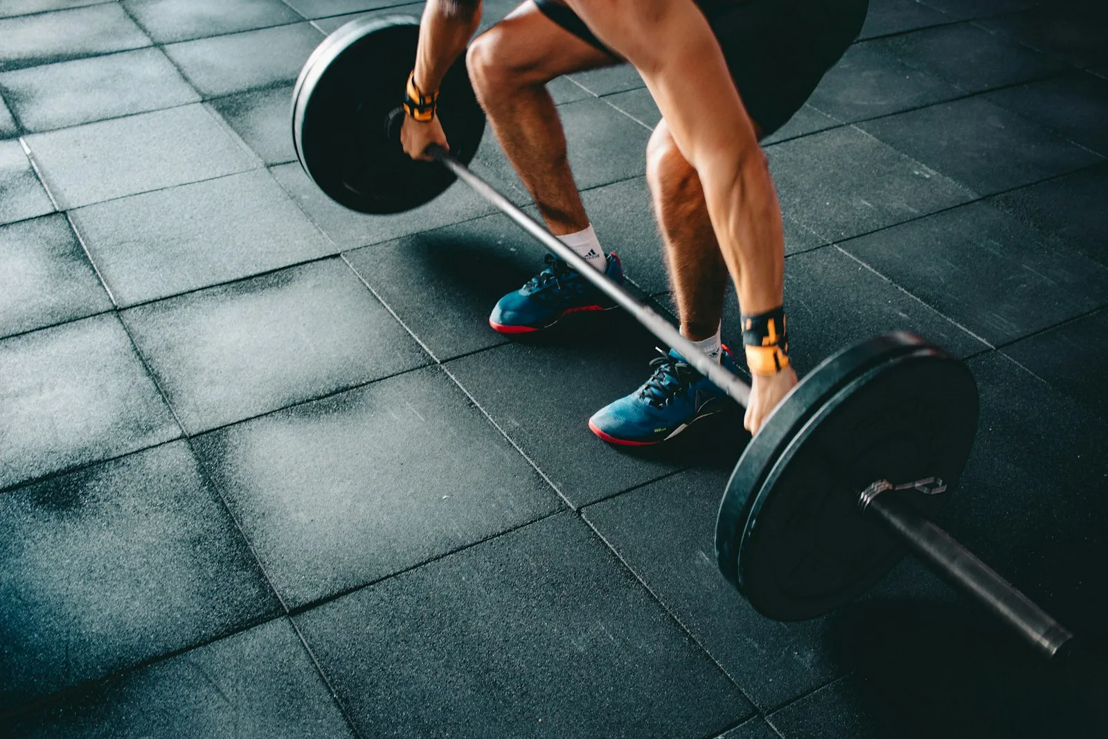 Lifter gripping a loaded barbell