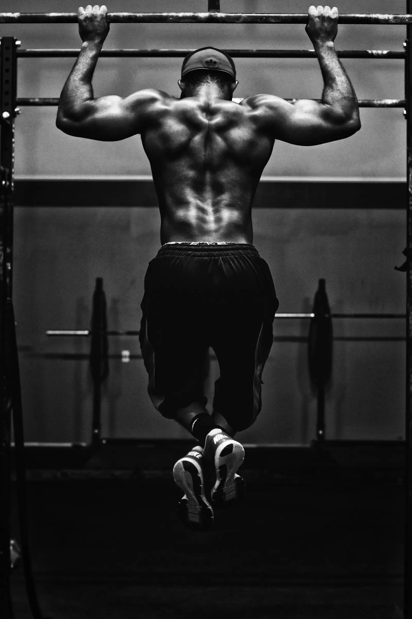 Athlete's back during a pull-up, black and white